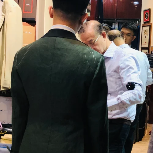 Bespoke Tailor Helping Customer